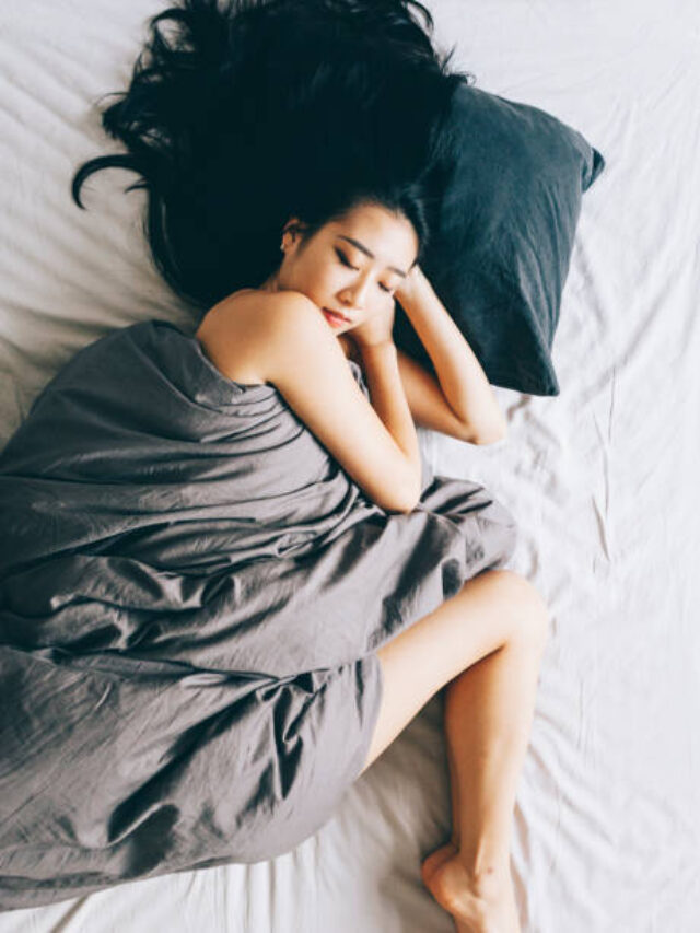 Young Asian woman sleeping in bed